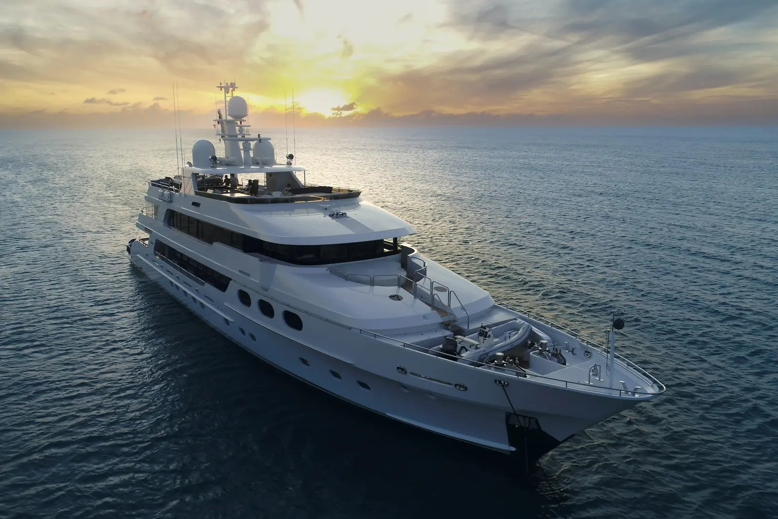 Kalyka, a tri-deck motor yacht, at anchor at sunset