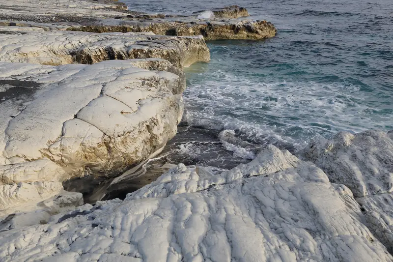 Waves washing over the white limestone rocks at Governor’s Beach