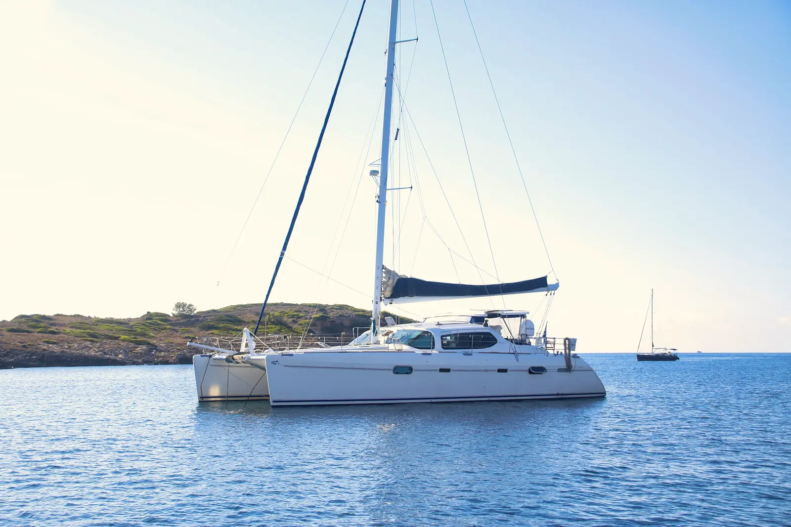 Pelagia, a sailing catamaran, at anchor in a calm bay
