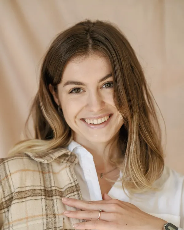 Portrait of Rafaella laughing, in a checked shirt