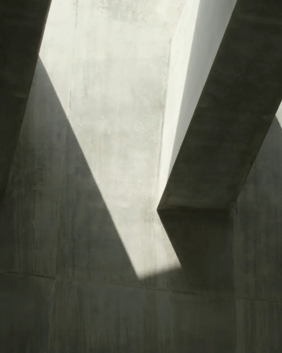 Light and shadow across a board-formed concrete wall