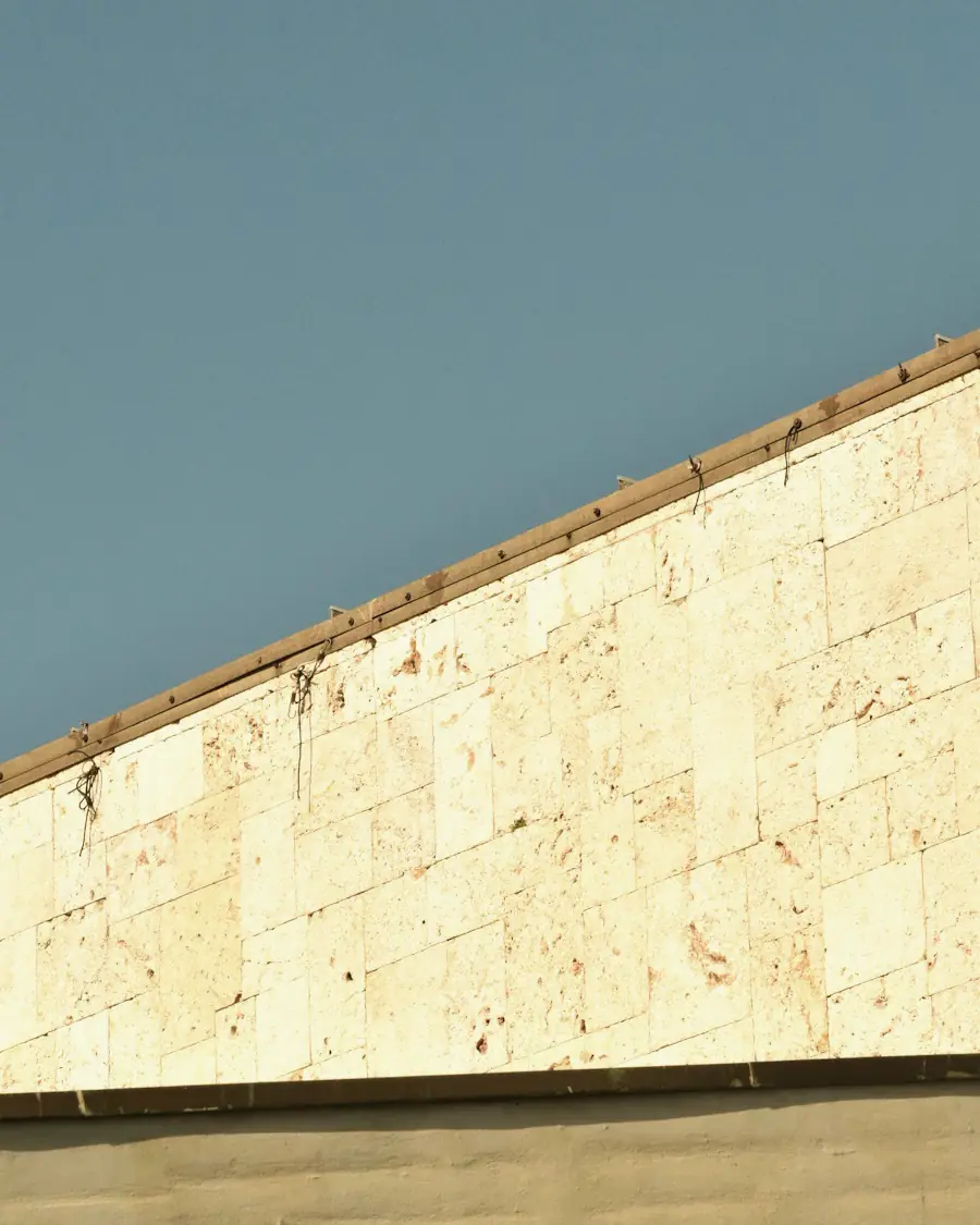 Honed limestone wall against the sky
